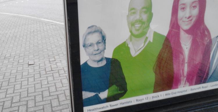 The corner of a laptop screen is visible. On the screen is a picture of three people.