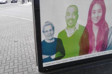 The corner of a laptop screen is visible. On the screen is a picture of three people.